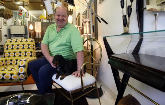Designer Peter Levis, with his dog Bonsai, at his Hingham shop Beyond Gorgeosity.
